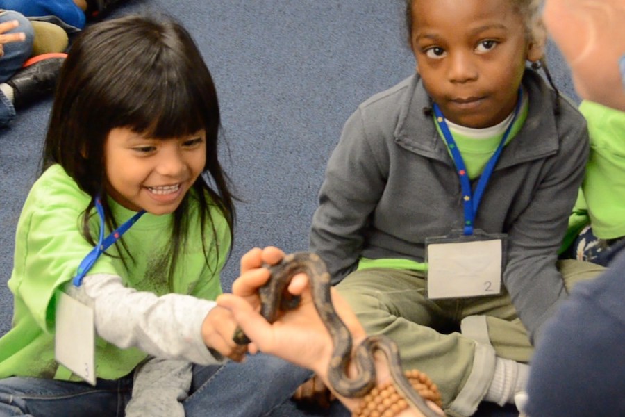 students pet a snake in Dominion Energy School Programs