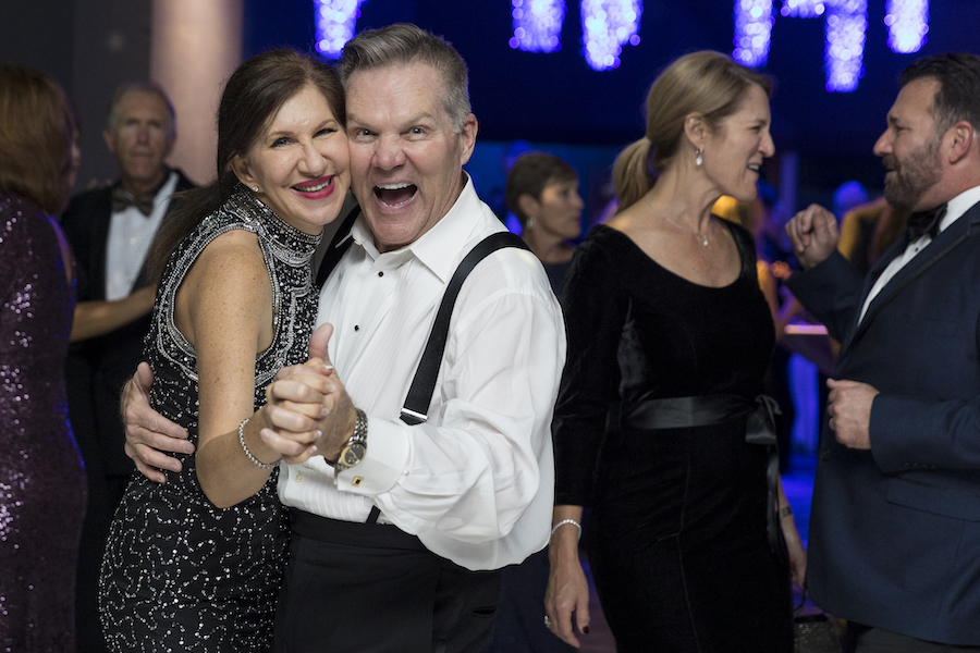 a couple dances in the crowd of the South Carolina Aquarium Conservation Gala