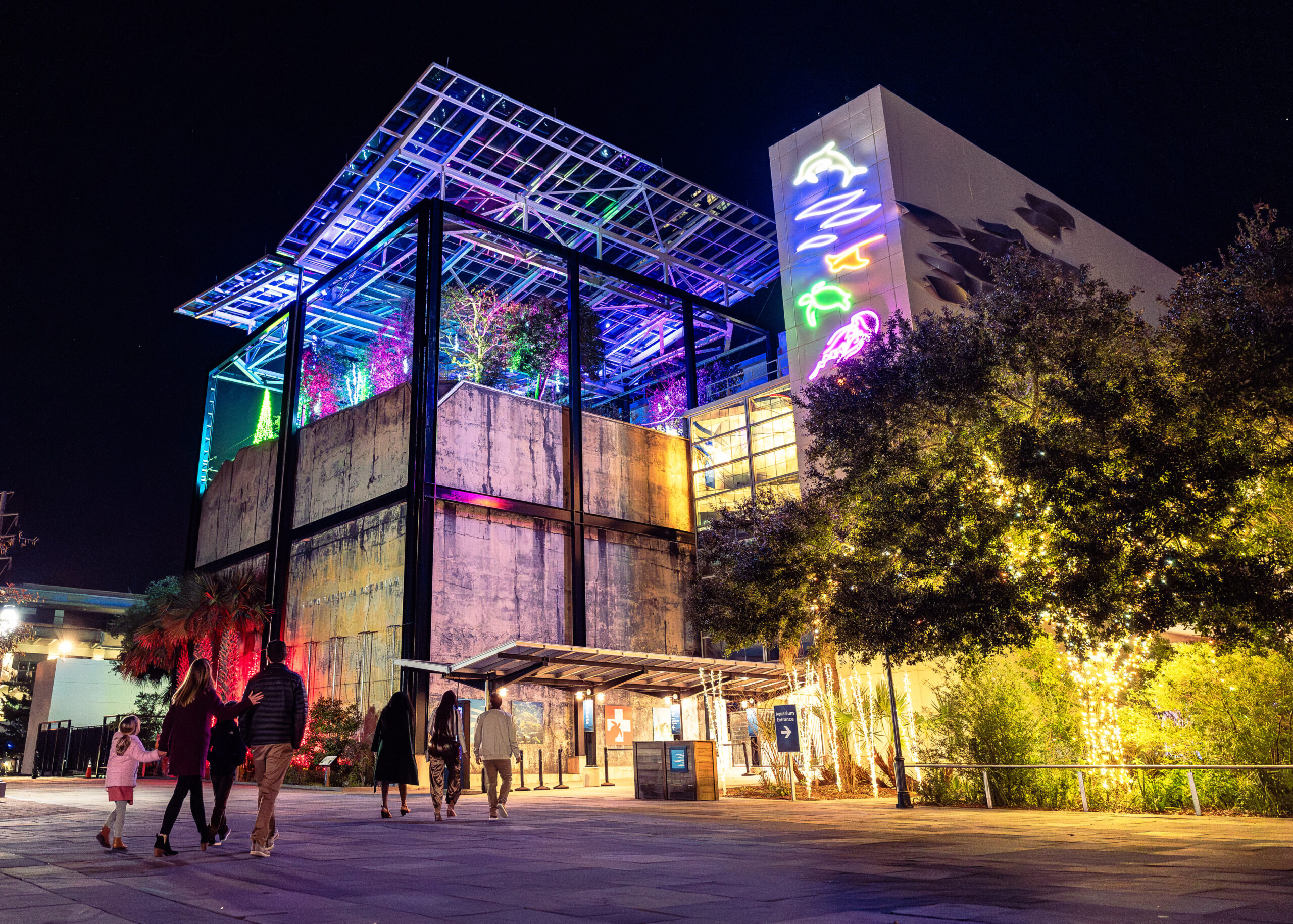 Guests walk up to the South Carolina Aquarium during their holiday light event, Aquarium Aglow